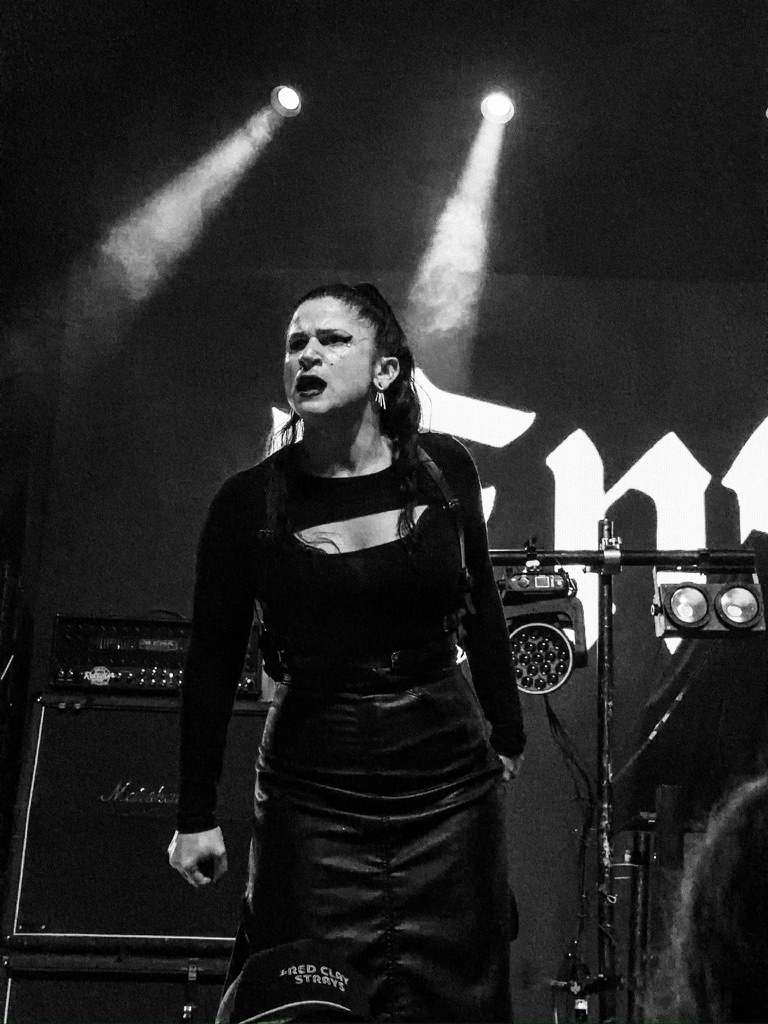 Chaney Crabb of Entheos in full voice, backlit by stage spotlights at Emo's Austin.
