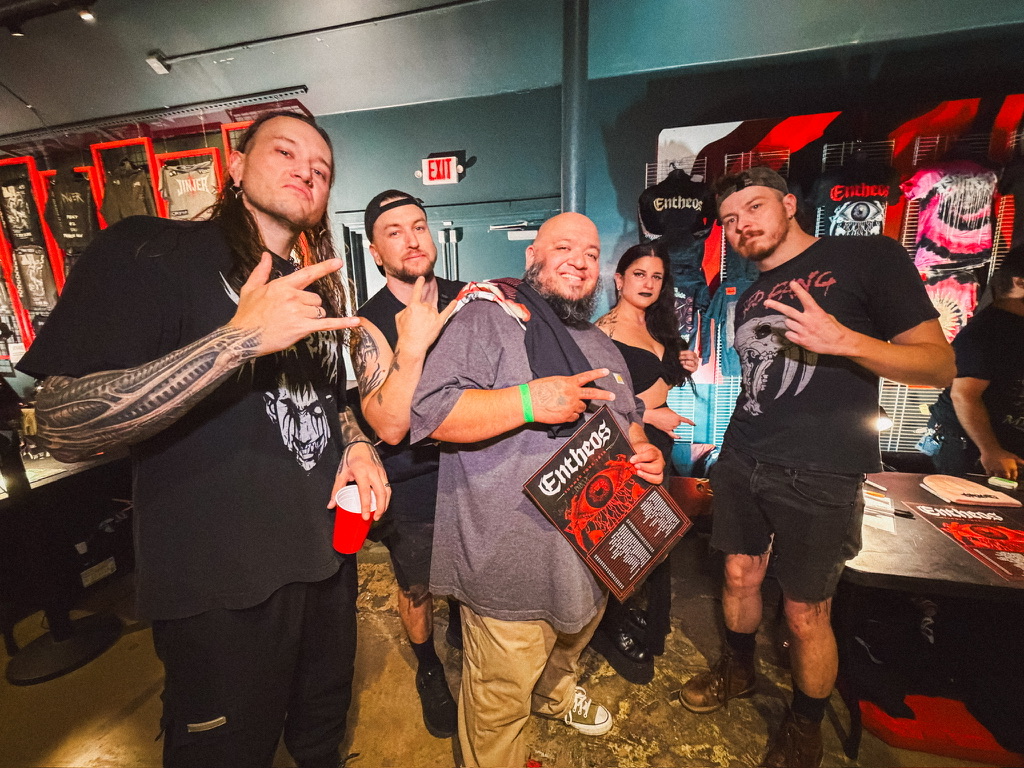 Tanner with the members of Entheos at the merch table at Emo's Austin.
